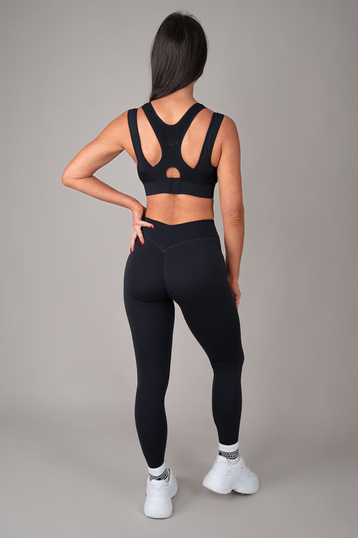 Black high support sports bra on model oufit back view